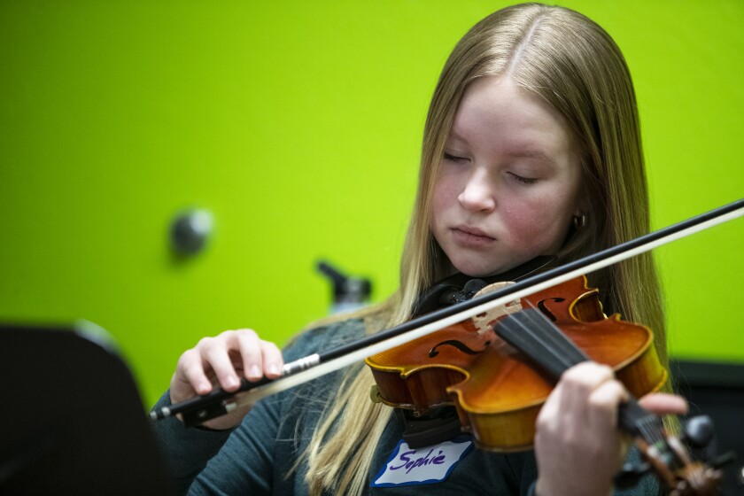 Sophie Haase, 13, of Murdoch, practices with her group during a free fiddle workshop at Hope Lutheran Church in Sunburg on Sunday, April 3, 2022.