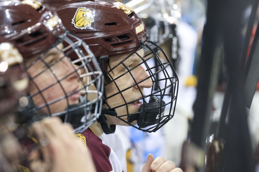 college men play ice hockey