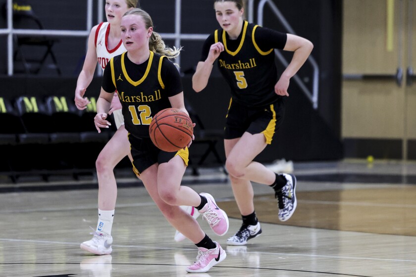 high school girls play basketball