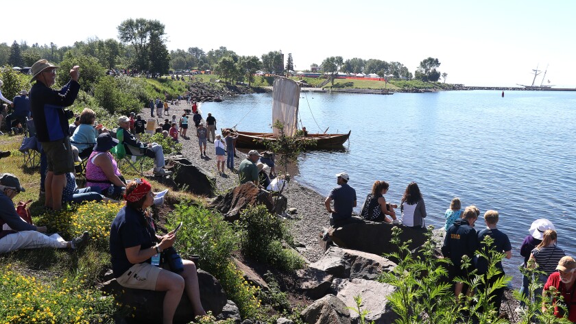 People on shore looking out at the lake.