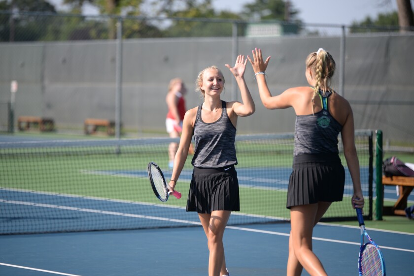 Litchfield's Laney Huhner celebrates winning a point with doubles partner Vaida Behnke Wednesday morning in Litchfield in a match against Willmar. Jake Schultz / Tribune