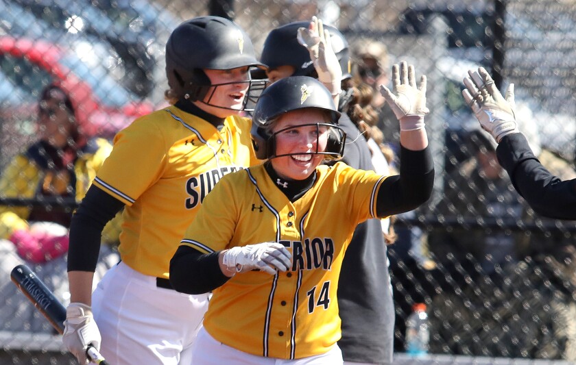 UW-Superior’s Jessica Jacobson (14) and Ellie Macal (21) are greeted by teammates at home after scoring