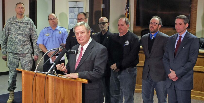 Gov. Jack Dalrymple speaks about the ongoing protest and especially the events of the past week in Bismarck and Mandan on Friday, Nov. 19, 2016. Behind him, from left, are Gen. Alan Dohrmann, Bismarck Police Chief Dan Donlin, Mandan Police Cchief Jason Ziegler, Bismarck Mayor Mike Seminary, Mandan Mayor Tim Helbling, Morton County Commissioner Cody Schulz and Lt. Gov. Drew Wrigley. TOM STROMME / BISMARCK TRIBUNE