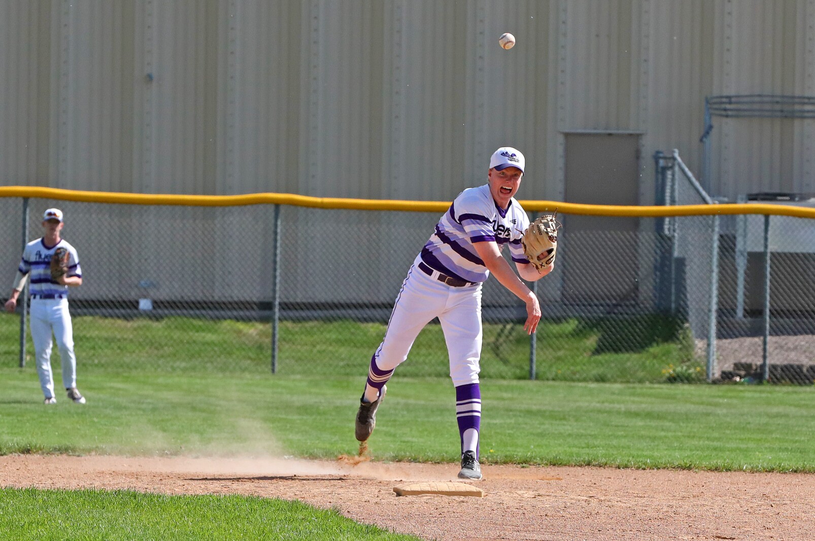 Little Falls' Collin Kray throws to first base against Sauk Rapids on Friday, May 27, 2022, at Little Falls.