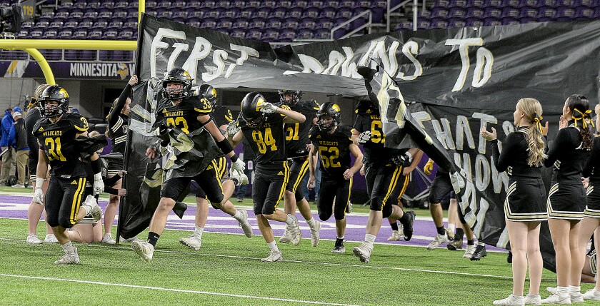 The NLS football team runs onto the field for the second half of the Class AAA state semifinals against Watertown-Mayer on Saturday, Nov. 19, 2022 at U.S. Bank Stadium in Minneapolis.