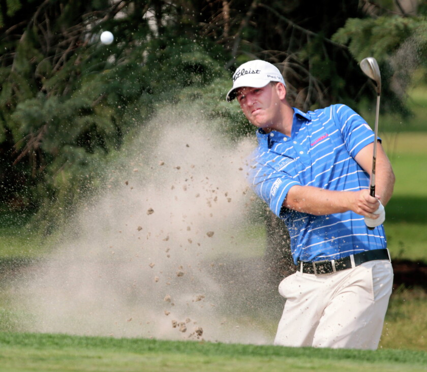 Tom Hoge watches his shot out of the sand trap on the 10th hole during the North Dakota Bobcat Open golf tournament Sunday, August 30, 2015, at the Fargo Country Club. Dave Wallis / The Forum