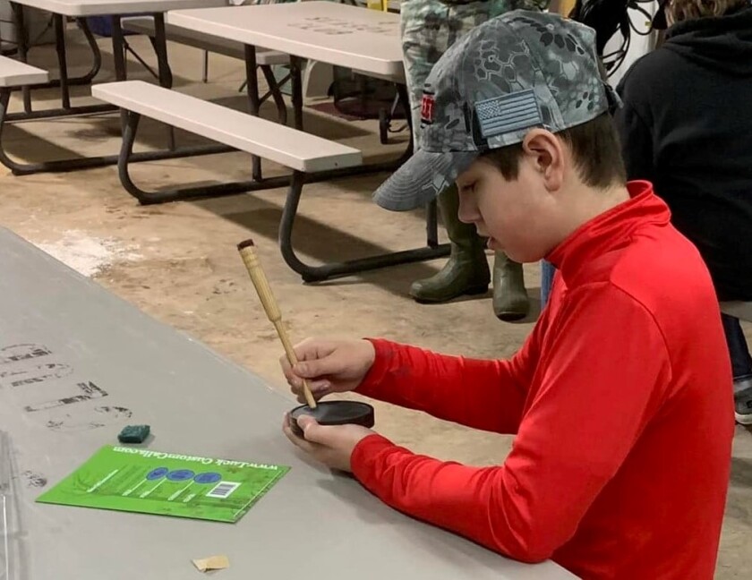 youth with slate turkey call