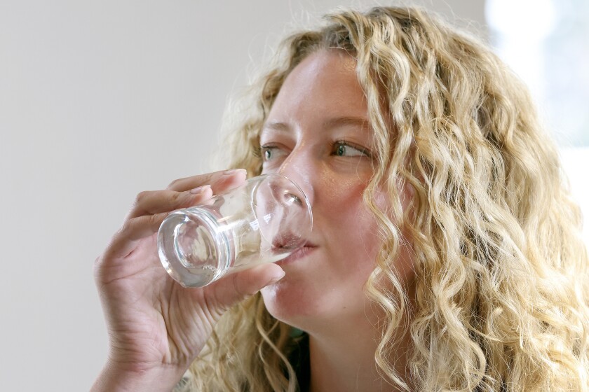 Woman drinking a cider.