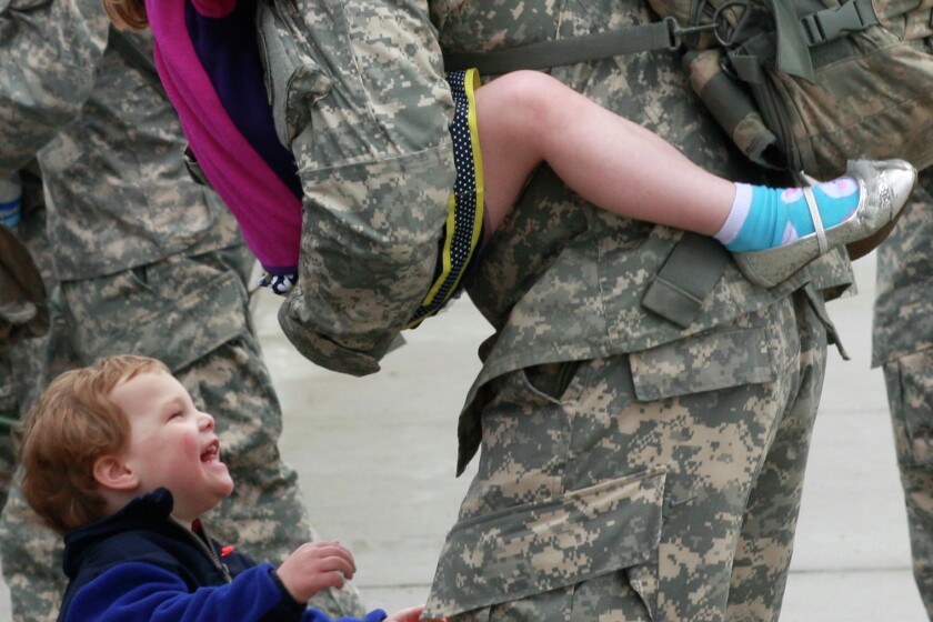 Ssgt. Chris McNeely of Grand Forks is reunited with his children