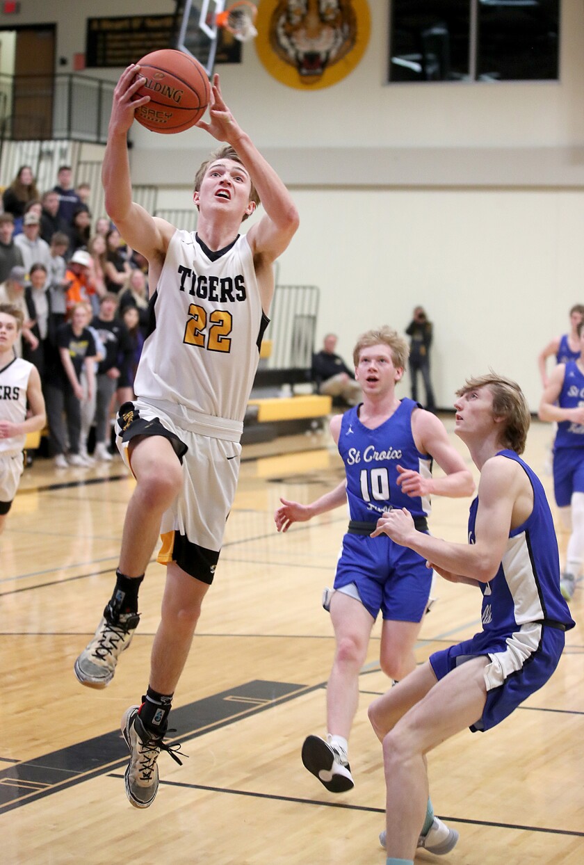 Northwestern’s Cole Lahti (22) glides to the hoop for a bucket