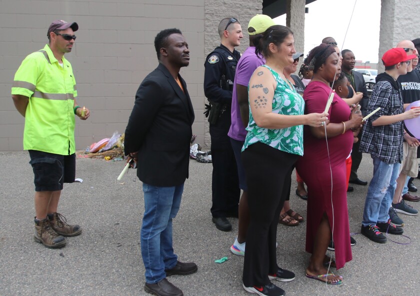 Patrick Peterson in bright yellow shirt at back on Friday, June 25 during the Liberian community candlelight service.jpg