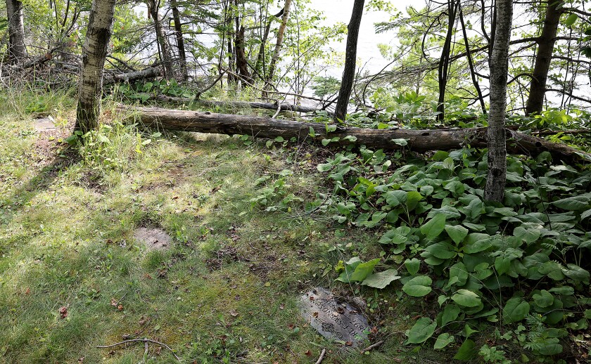 Headstones near eroding hill.