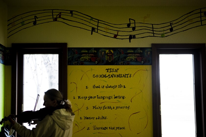 Nancy Streng of St. Joseph practices playing her violin alone in a classroom at Hope Lutheran Church Sunday, April 3, 2022 before a free fiddle workshop began.