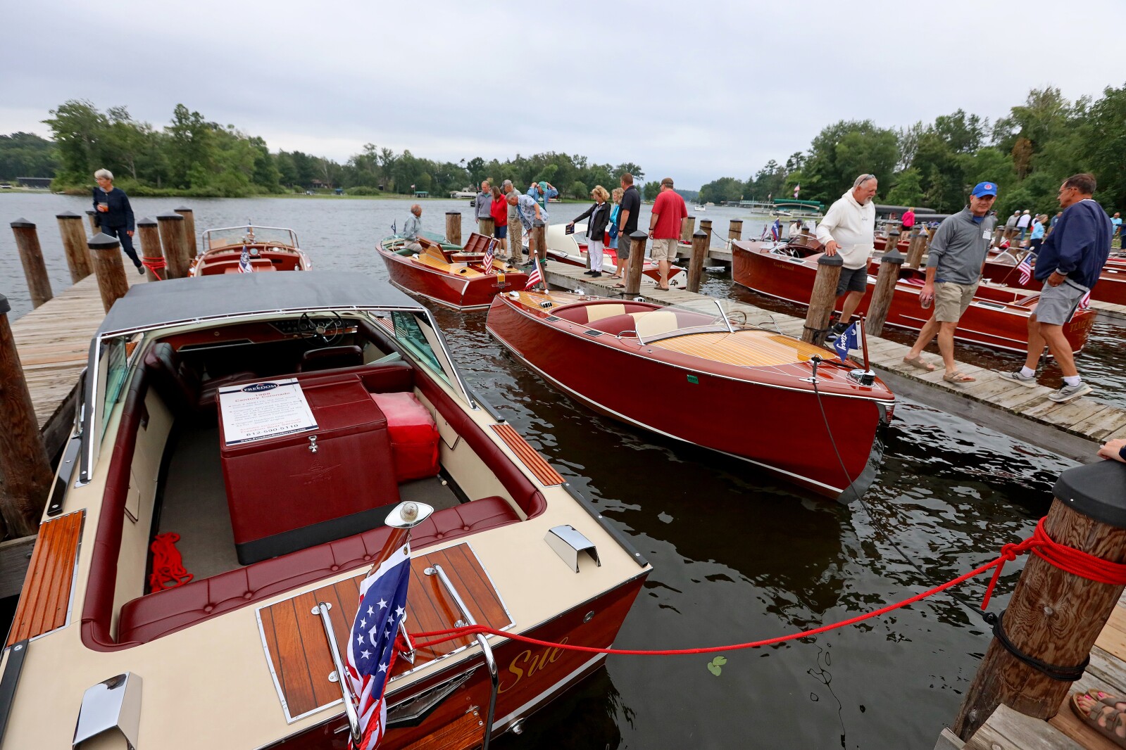Attendees admire classic boats on display Saturday, Aug. 27, 2022, during the annual Classic Boat Show at the Bar Harbor Supper Club in Lake Shore.