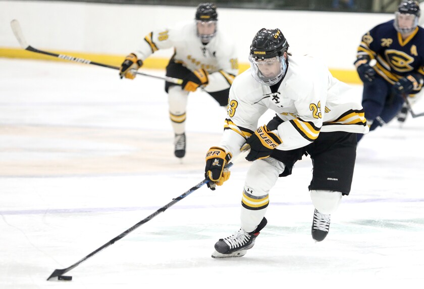 UW-Superior’s MacGregor Sinclair (23) moves the puck up the ice