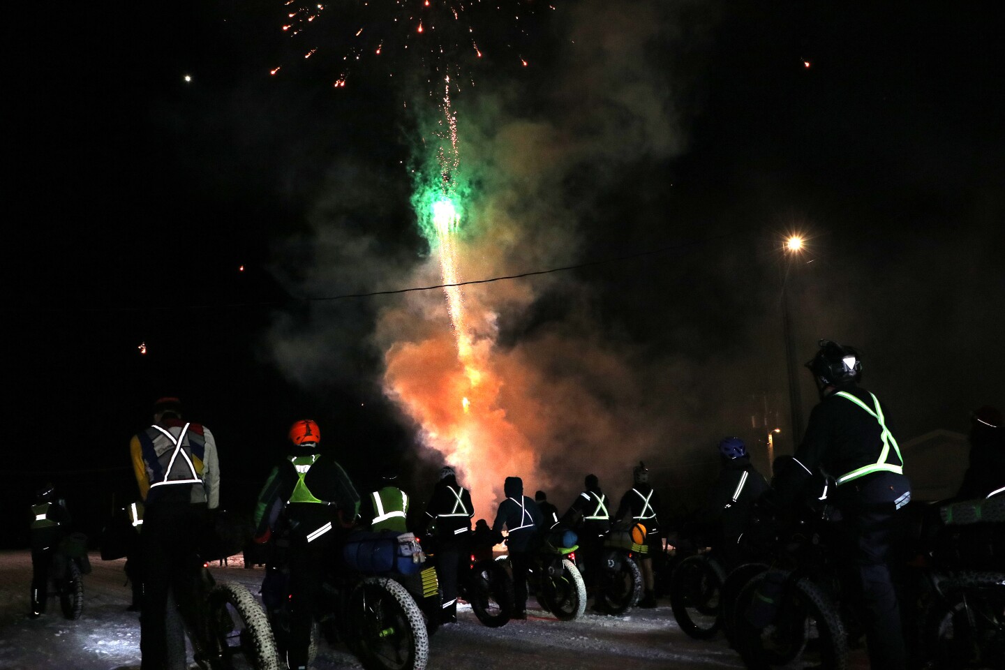 Bikers watch fireworks in the ski