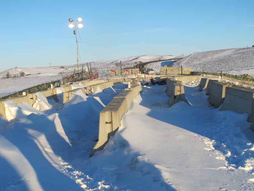 Snow-swept and desolate, the forbidding look at Backwater Bridge could be a thing of the past, depending on whether the bridge can be reopened following a damage assessment Thursday. The bridge symbolizes a divide created during the Dakota Access Pipeline protest. Photo by Lauren Donovan / Bismarck Tribune