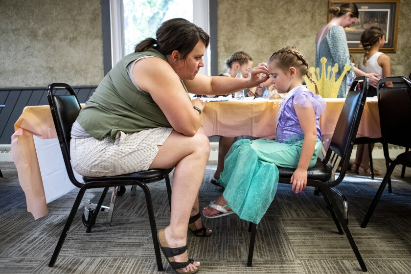 Nikke Niemeyer, at left, applies eye shadow to Kara Rosenau, 5, during Little Princess Night during Prairie Fest in Clara City on Friday, July 8, 2022.