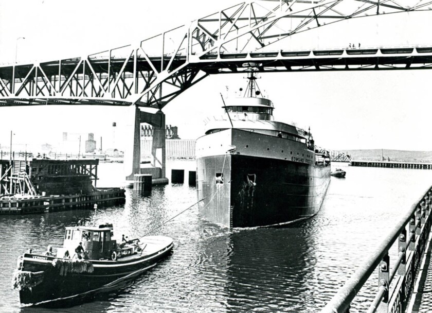 The freighter Edmund Fitzgerald is guided by the tug Vermont through the opening in the Interstate Bridge in the Duluth-Superior Harbor in this undated photo from the 1960s. (News Tribune file photo)
