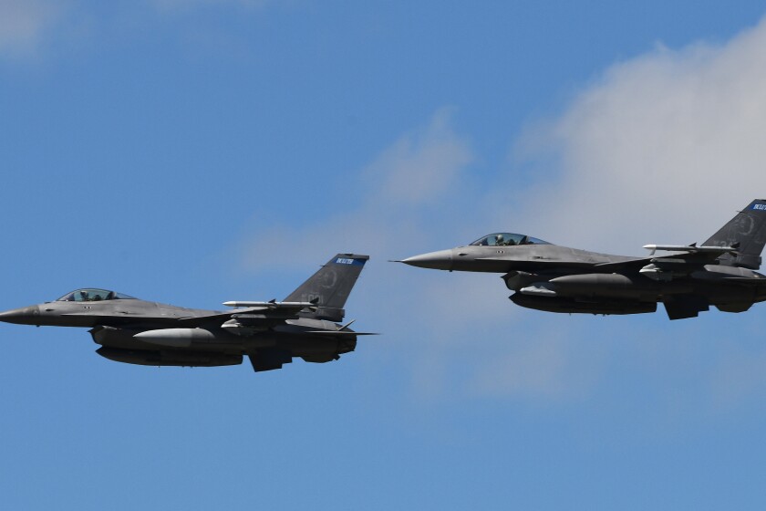 On the final day of the American Barnstormer Tour stop at the Brainerd Lakes Regional Airport Tuesday, July 17, a pair of F-16s flew over the crowd. With the event featuring the golden era of flight in the late 1920s, the jet aircraft illustrated the dramatic change in air travel. The roar of the barnstormers could be heard since Sunday in the skies over Brainerd. Steve Kohls / Brainerd Dispatch