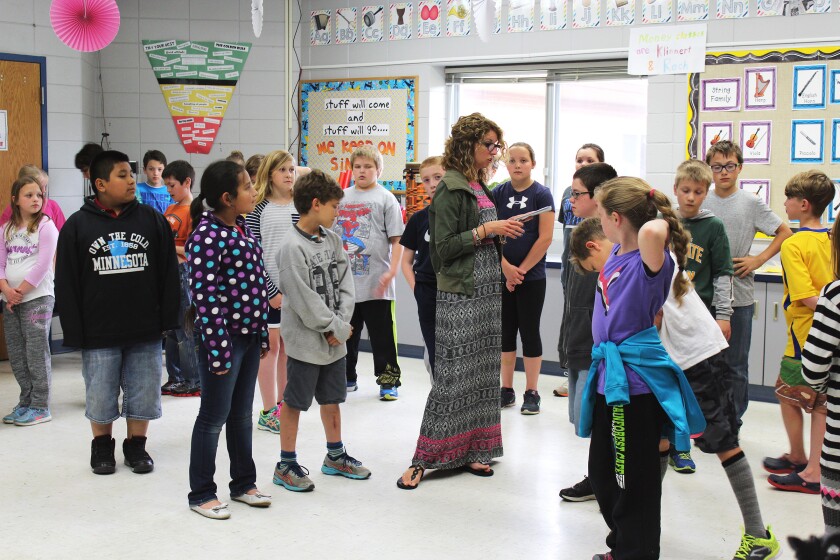 During a rehearsal Monday, Heidi Swenson, a.k.a. "Mademoiselle Louise," runs lines with students in the Heart of the Lakes Elementary School music room. Marie Johnson/FOCUS