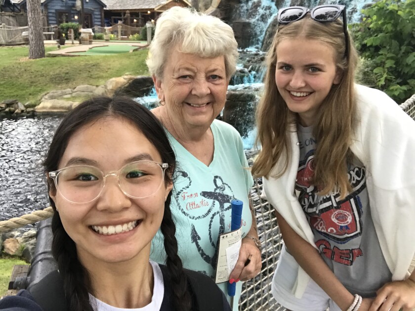 The females pose for a photo while playing mini golf.