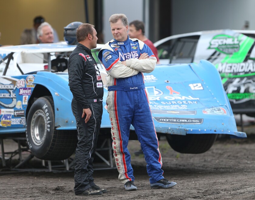 Donny Schatz, left, and Brad Seng chat before they raced their late models at River Cities Speedway on Friday night. photo by Eric Hylden/Grand Forks Herald