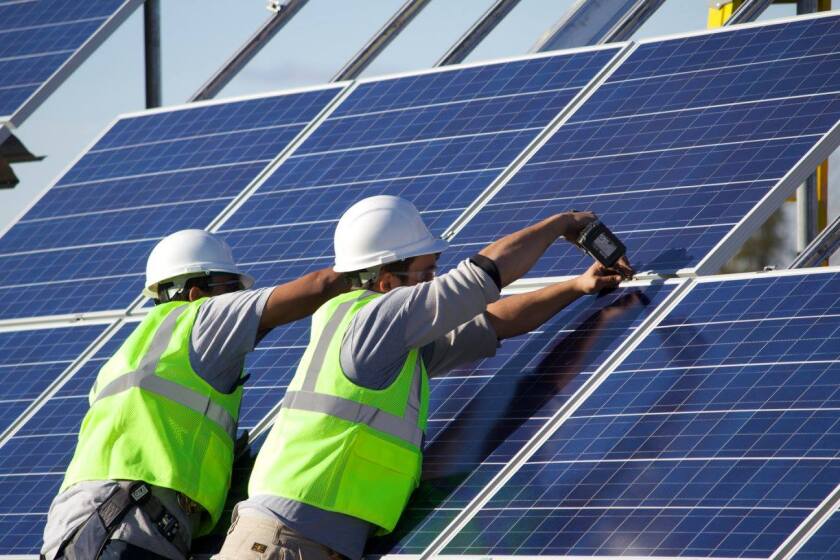 Rural Renewable Energy Alliance workers install a community-based solar project. RREAL and the Leech Lake Band of Ojibwe installed five solar arrays to benefit low-income households. Submitted photo