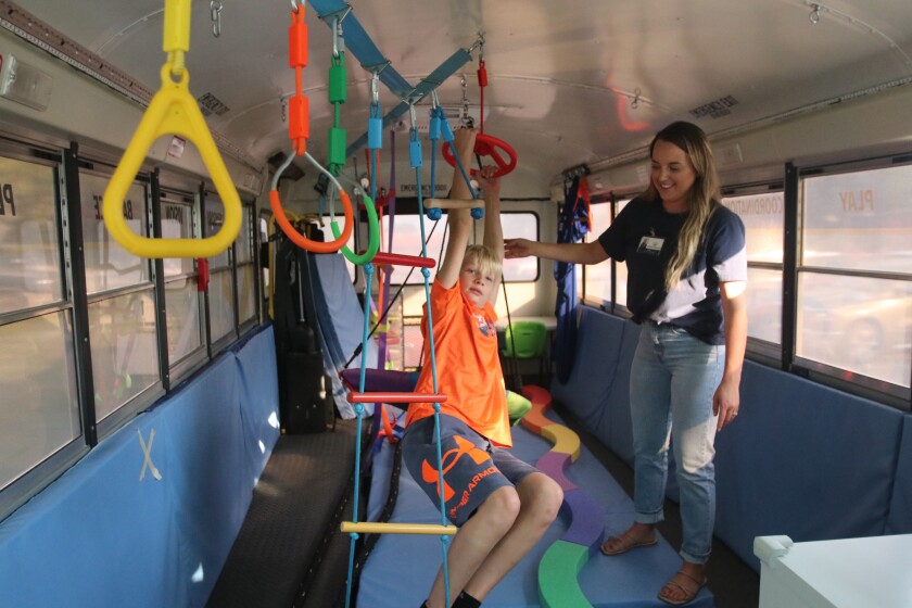 Physical therapist Bobbie Sunderland working with 10-year-old Reese Hogness on the Beyond Boundaries Therapy Bus on Sept. 8, 2022.jpg