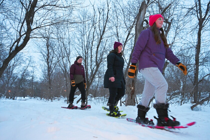 three women snowshoeing
