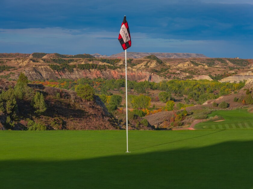 Hole 15 at Bully Pulpit Golf Course is shown with a beautiful backdrop of the Badlands during an evening in September of 2021.