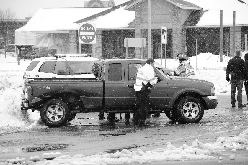 Emergency personnel work to care for the driver of a Ford truck who was injured after a two-vehicle crash on Highway 371 North and Clearwater Road in Baxter Wednesday. Steve Kohls/Brainerd Dispatch