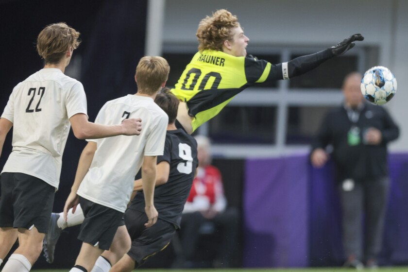 boys soccer players playing in indoor stadium