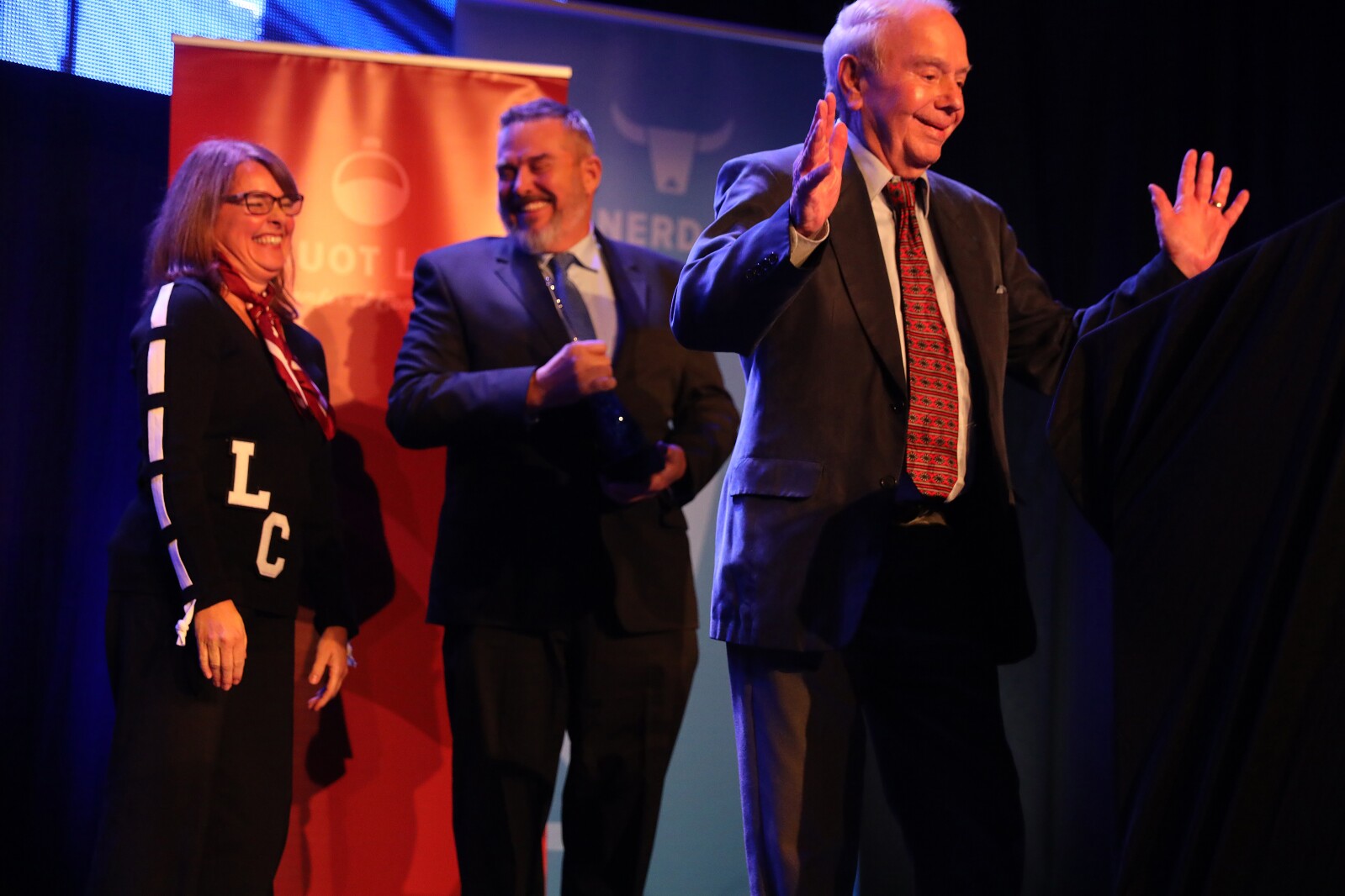 Bob Spizzo gestures as presenters laugh