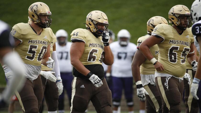 Linemen walk towards line of scrimmage