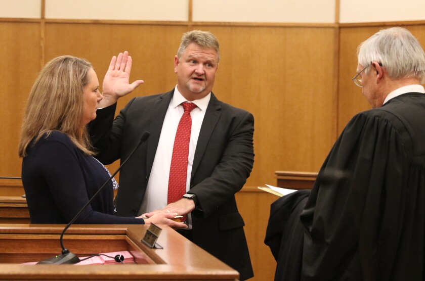 Erica Strandlie Friday holds the Bible for husband Christopher Strandlie as he is sworn in as a Ninth District judge in Crow Wing County District Court by Judge Earl Maus. Kelly Humphrey / Brainerd Dispatch - Gallery and Video