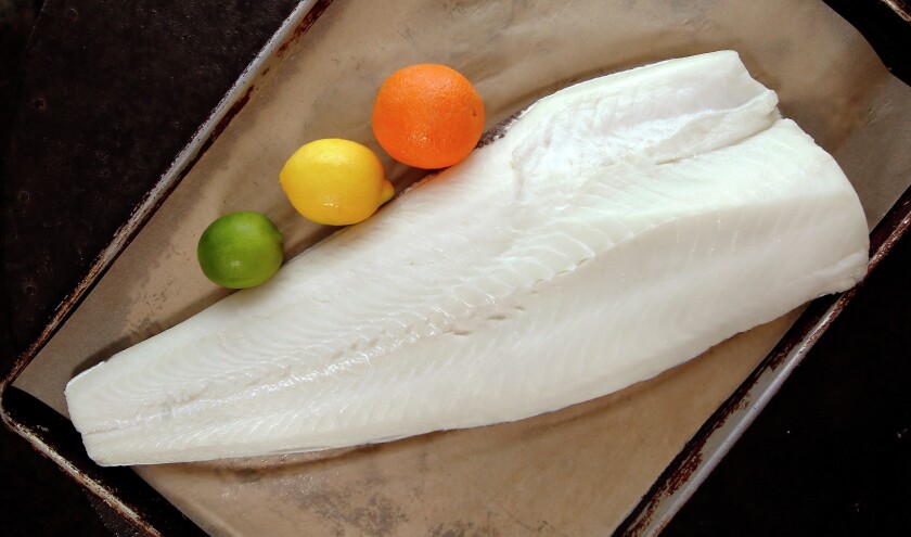 Sarello’s Signature Sea Bass is prepared along with a citrus sauce, wild rice pilaf and sugar snap peas at Sarello's in Moorhead. Dave Wallis / The Forum