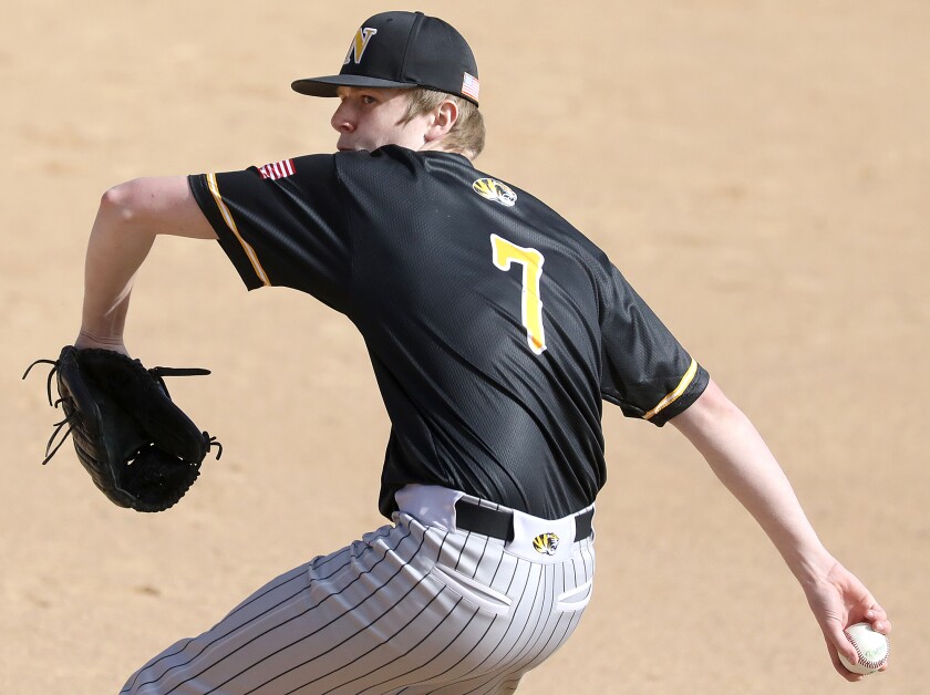 Northwestern’s Tyler Nelson (7) looks over his shoulder as he delivers a pitch