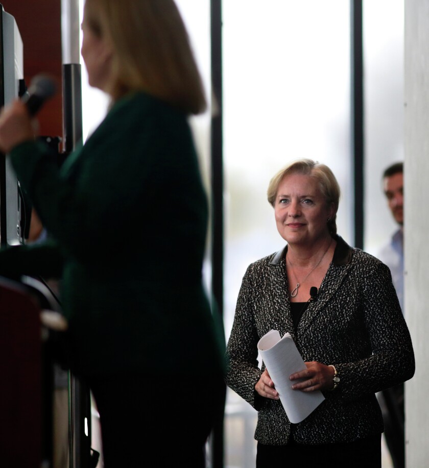 Margaret L. Williams , dean of UND College of Business and Public Administration, left, introduces Sally Smith, President and CEO of Buffalo Wild Wings, Friday at the Gorecki Alumni Center at UND. photo by Eric Hylden/Grand Forks Herald