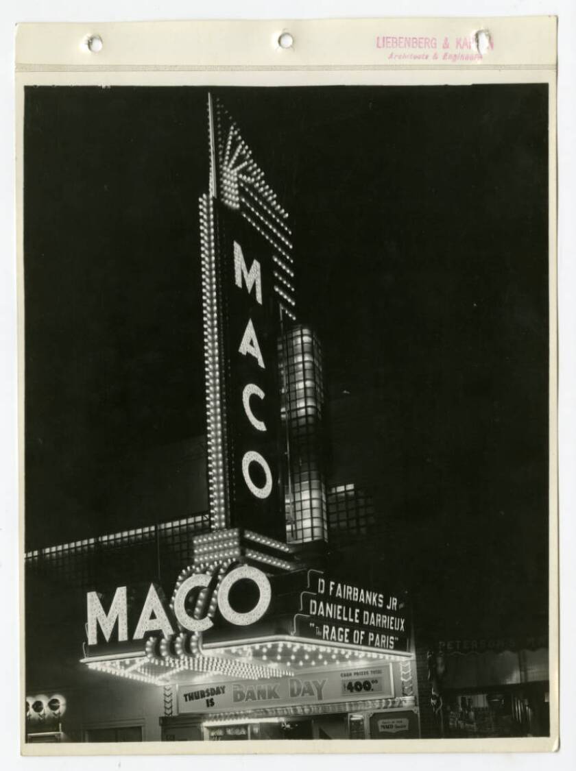 A movie theater marquee is lit up at night.