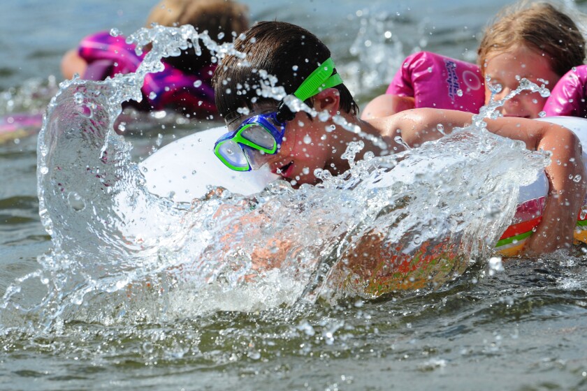 Before a late afternoon storm drove the 92-degree temperature into the 60s Tuesday, May 29, in a matter of minutes, Levi Jennings and his friends played in the water at Whipple Beach in Baxter. Steve Kohls / Brainerd Dispatch