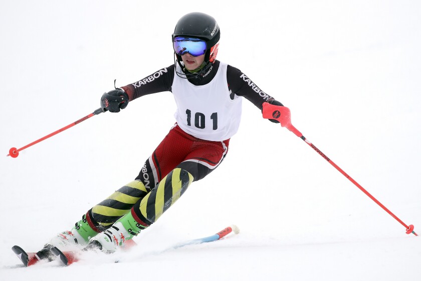 Skier races down the hill.