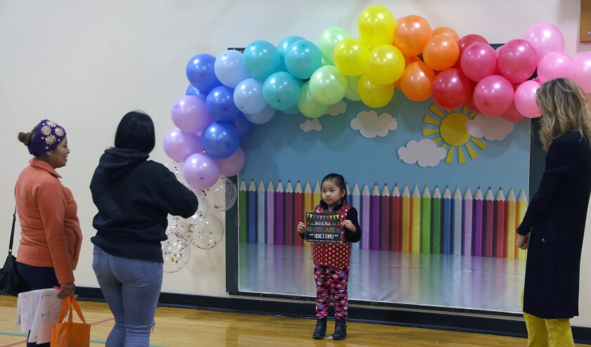 Family takes a photo of their future kindergarten student during Kindergarten Round-Up at Prairie Elementary in Worthington Monday morning.