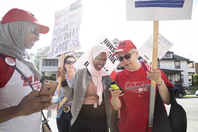 Ilhan Omar speaks with nurses and staff