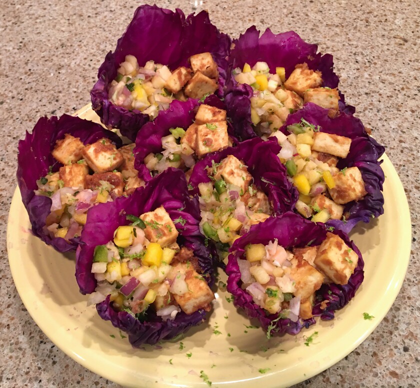 Plate of purple cabbage cups filled with cubed tofu and chopped vegetables