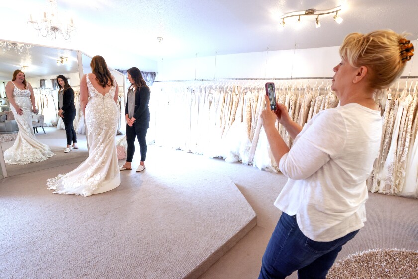 Trying on wedding dresses.
