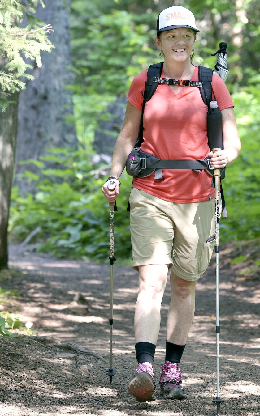 Jen Theisen hikes a trail in Cascade River State Park in late July. Theisen occasionally suffers from exercise-induced vasculitis, commonly called hiker’s rash, a harmless but painful condition marked by lesions and spots on legs, swelling, and intense itching, stinging, pain, or burning. Steve Kuchera / skuchera@duluthnews.com