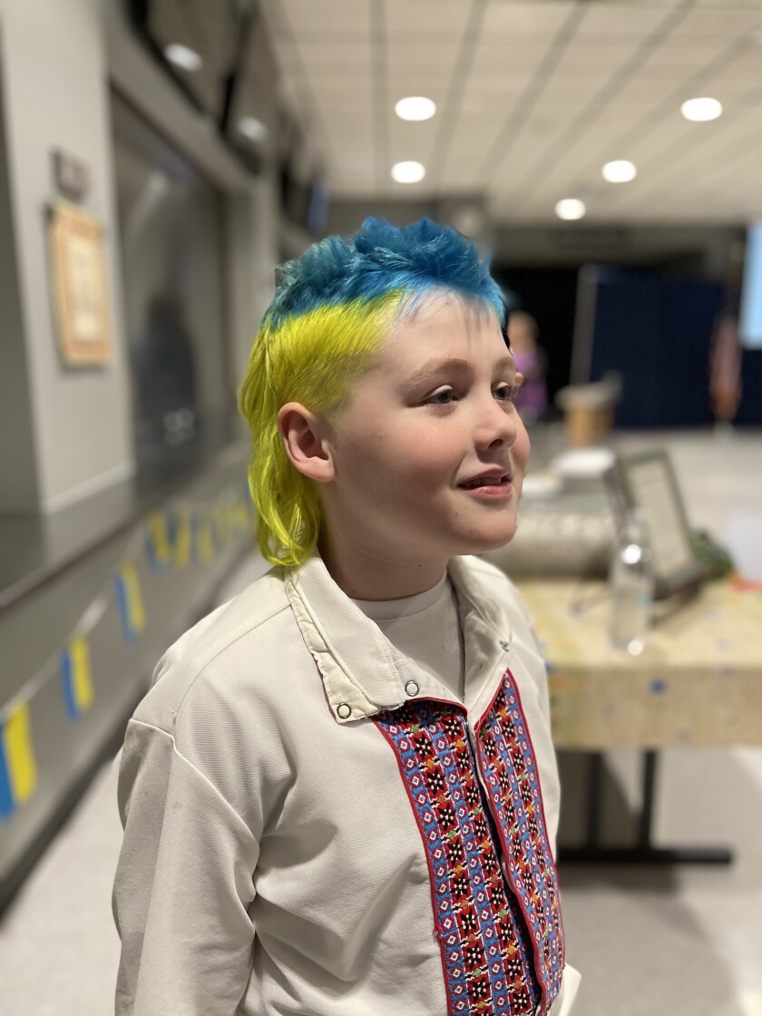 Deion Lindstrom, who's 9 years old and a fourth grader at Prairie Elementary in Fairfield, sports a blue and yellow mohawk, in support of Ukraine during a rally Monday, March 7, 2022, at the Biesiot Activities Center in Dickinson.