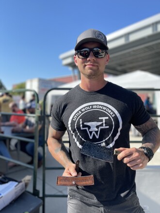 Cody Adolphson, a welder from Bismarck, shows off his meat cleaver he forged to auction off during the 10th Annual Bakken BBQ on Friday, June 17, 2022, in Dickinson.