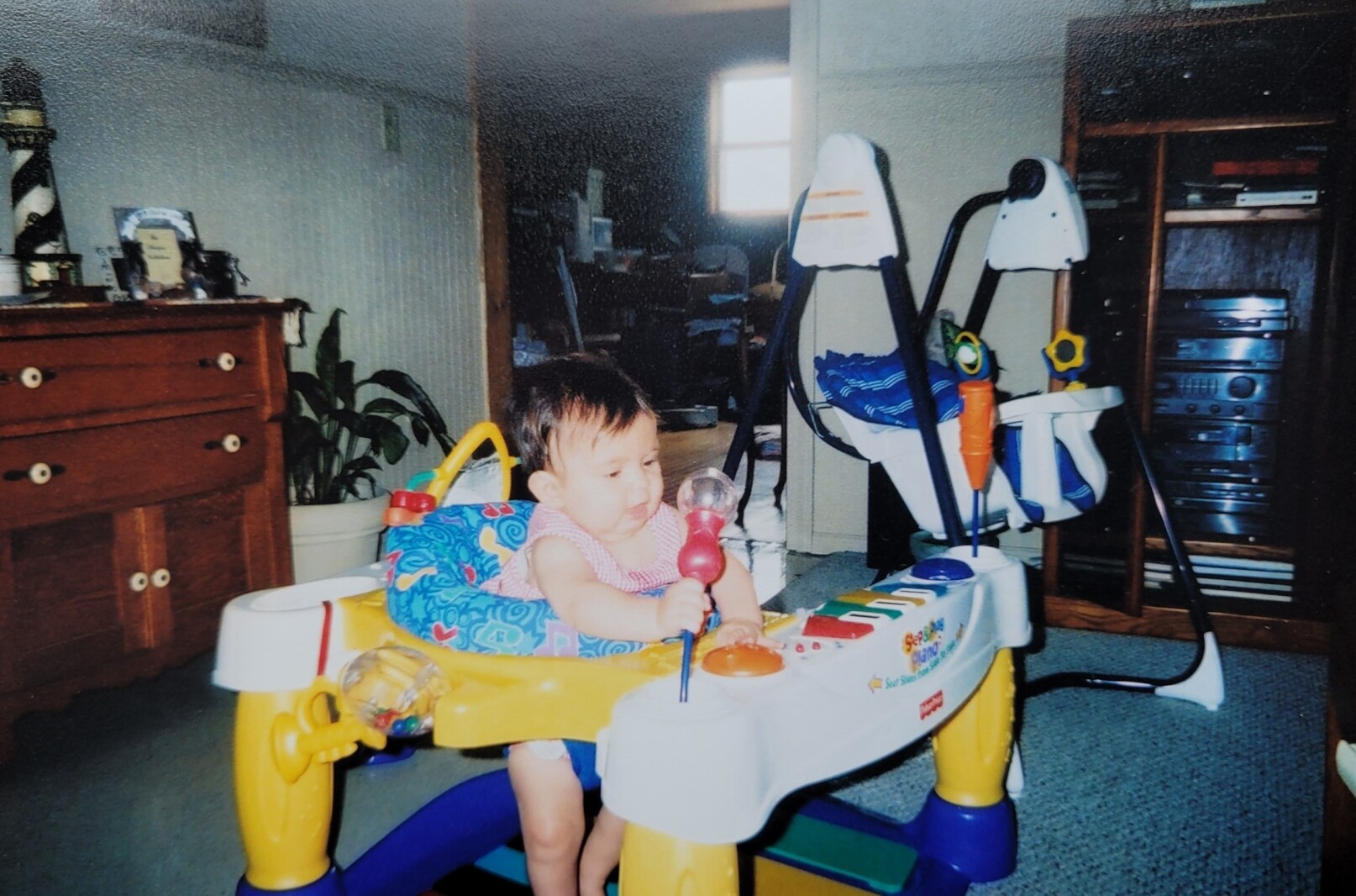 An infant plays in a jumper